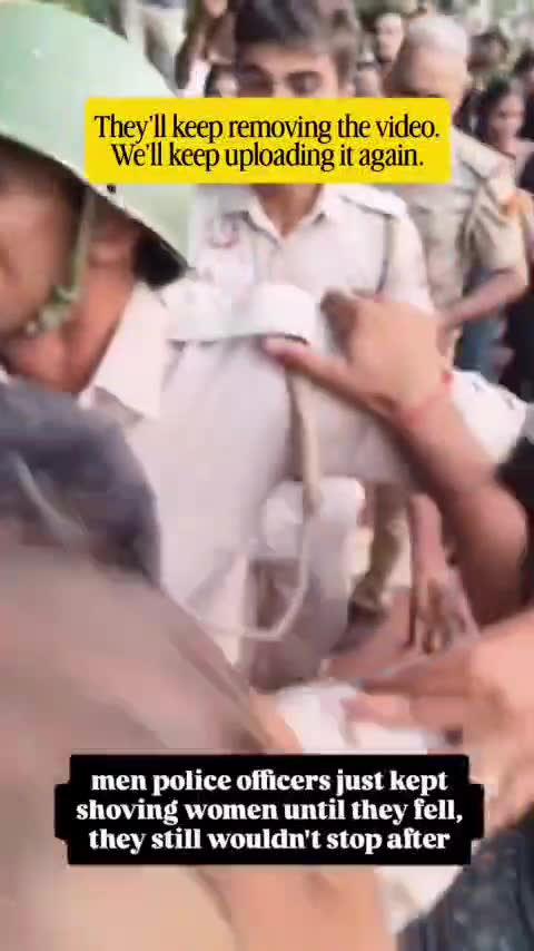 Male police officers shove women protesters