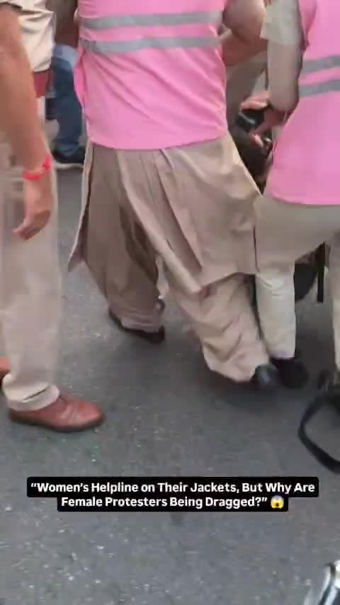 Women's helpline officers drag a protester