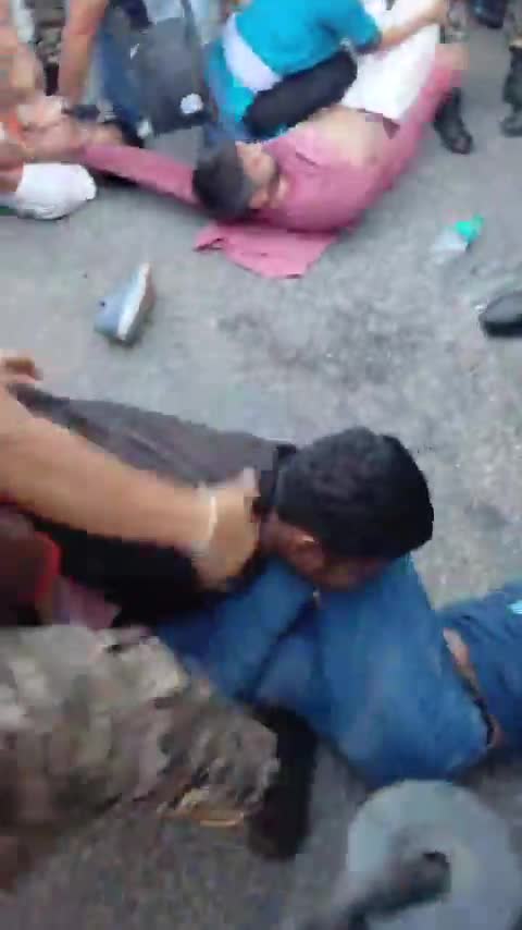 Protesters pinned and dragged on the road