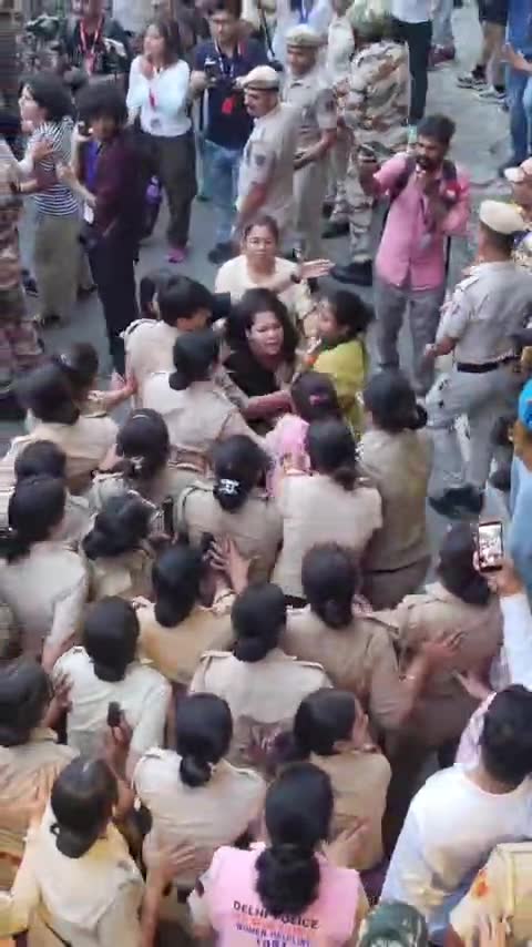 Crowd of women police surround protesters